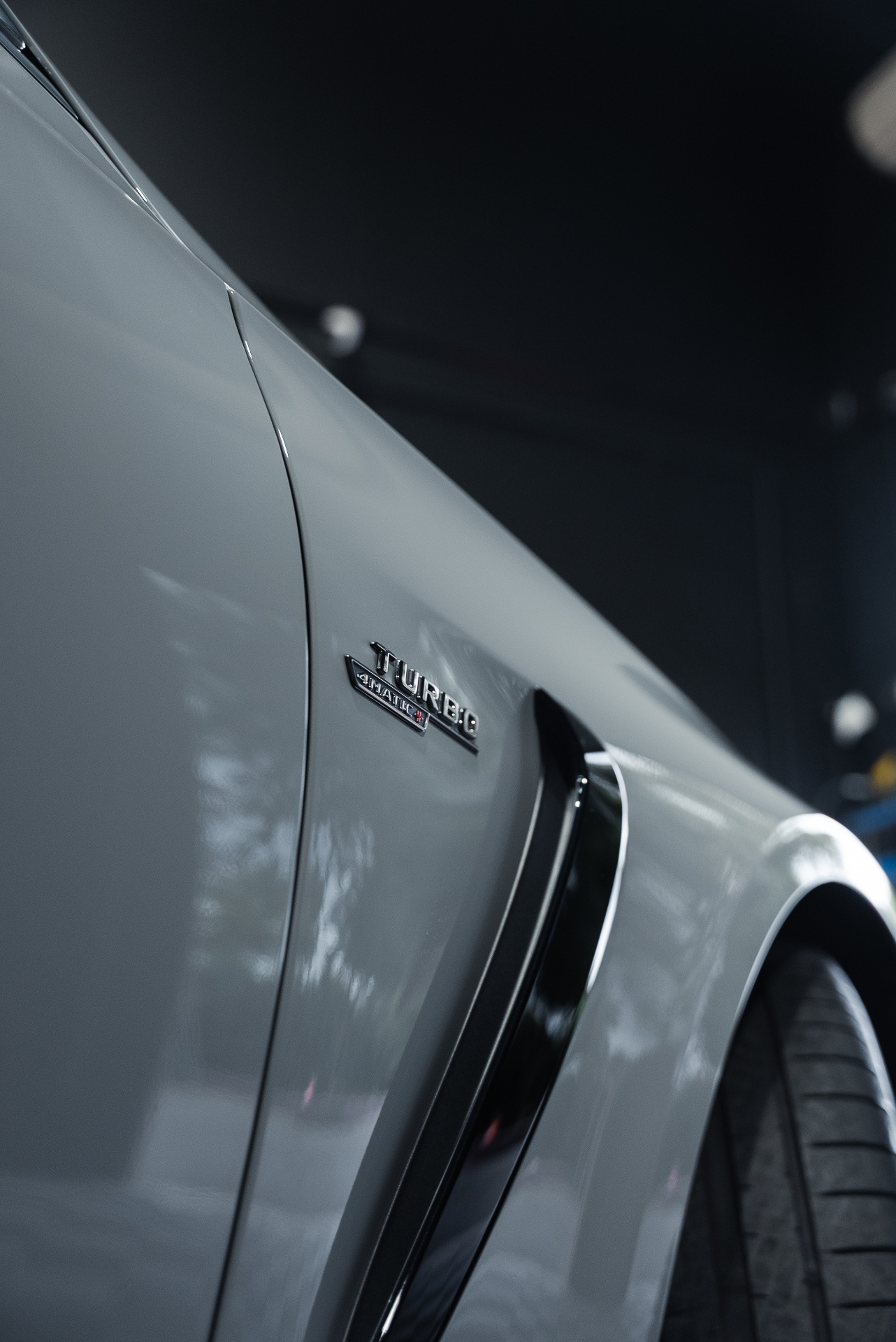 Mercedes-AMG Turbo 4MATIC+ badge close-up with PPF gloss finish